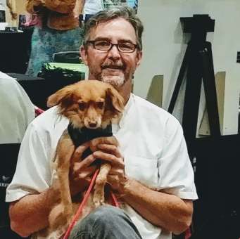 Joe teaches dogs how to behave well in public.